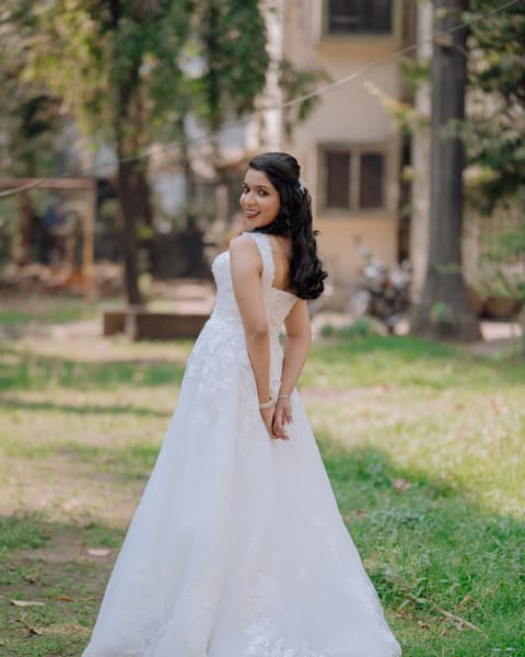Bride in her gown on a garden lawn