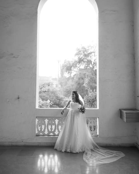 Bride in an arched window, in black and white